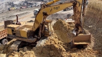 Old Hero in Action: Caterpillar 245B Excavator with Over 120,000 Working Hours Loading Overburden