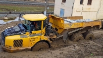 Cargo transportation off-road in dirt. Trucks work at the limit of their capabilities.