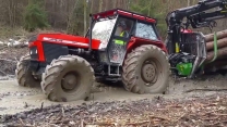 Powerful tractors operate in extreme off road conditions .Tractor drivers are stuck in the mud.